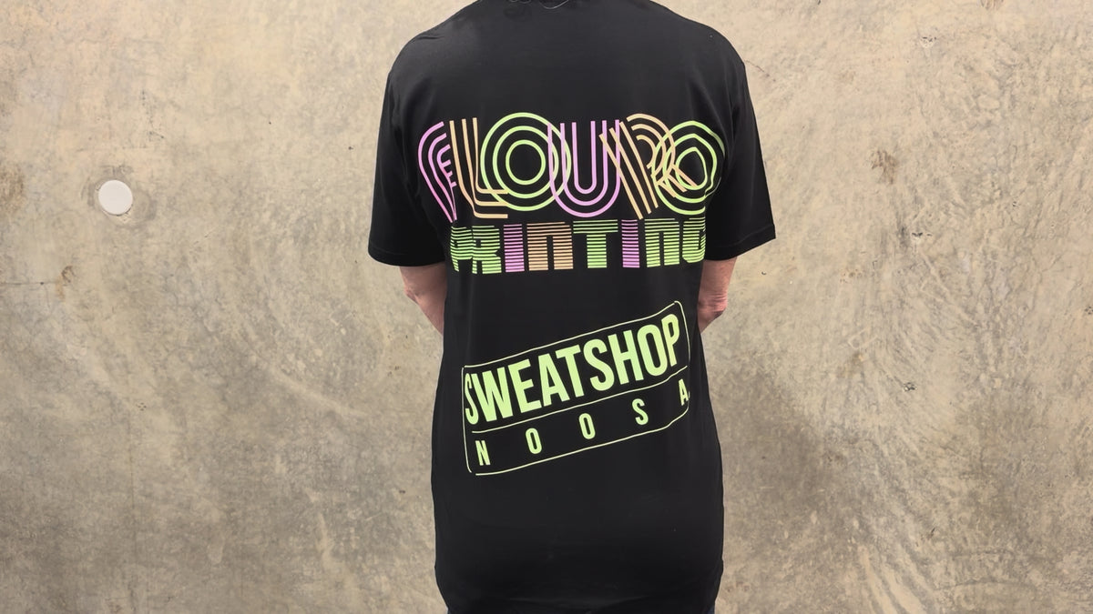 Load video: Fluorescent printed Sweatshop T-shirts shown under normal lighting and UV lighting